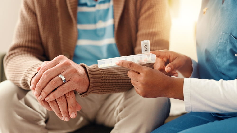 People, hands or nurse with pills for elderly patient, medication prescription or daily dosage.