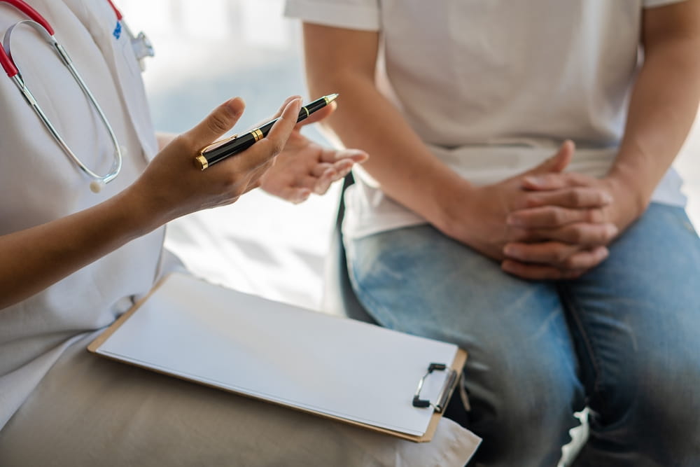 Doctors consulting patients with close-up hands patient sitting at the doctor's office,