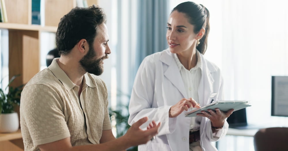 Doctor, patient or consulting with tablet for health advice, checkup or visit at clinic appointment