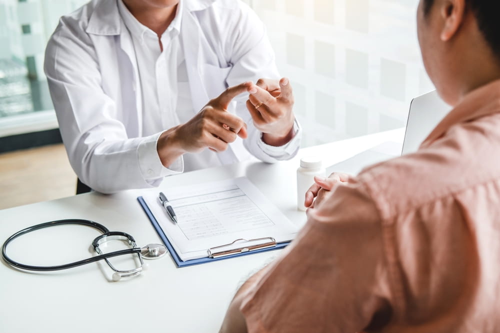 Doctors and patients consulting and diagnostic examining sit and talk. At the table near the window in the hospital medicine concept