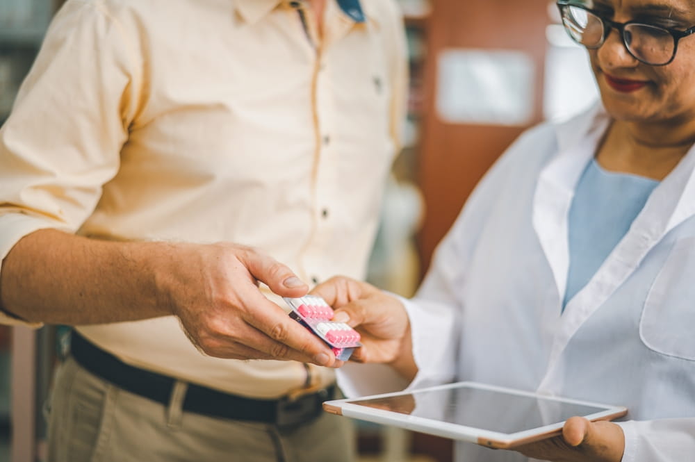 Pharmacist giving advice And advice for patients who come to buy Medicine, Drugs, Vitamins products,