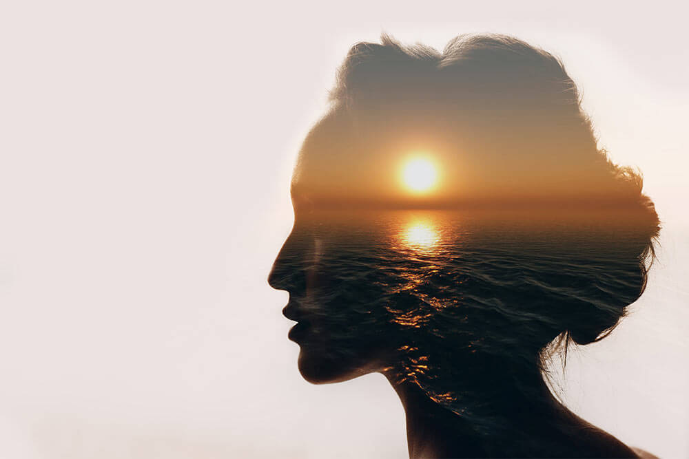 Sunrise and dreamer woman silhouette