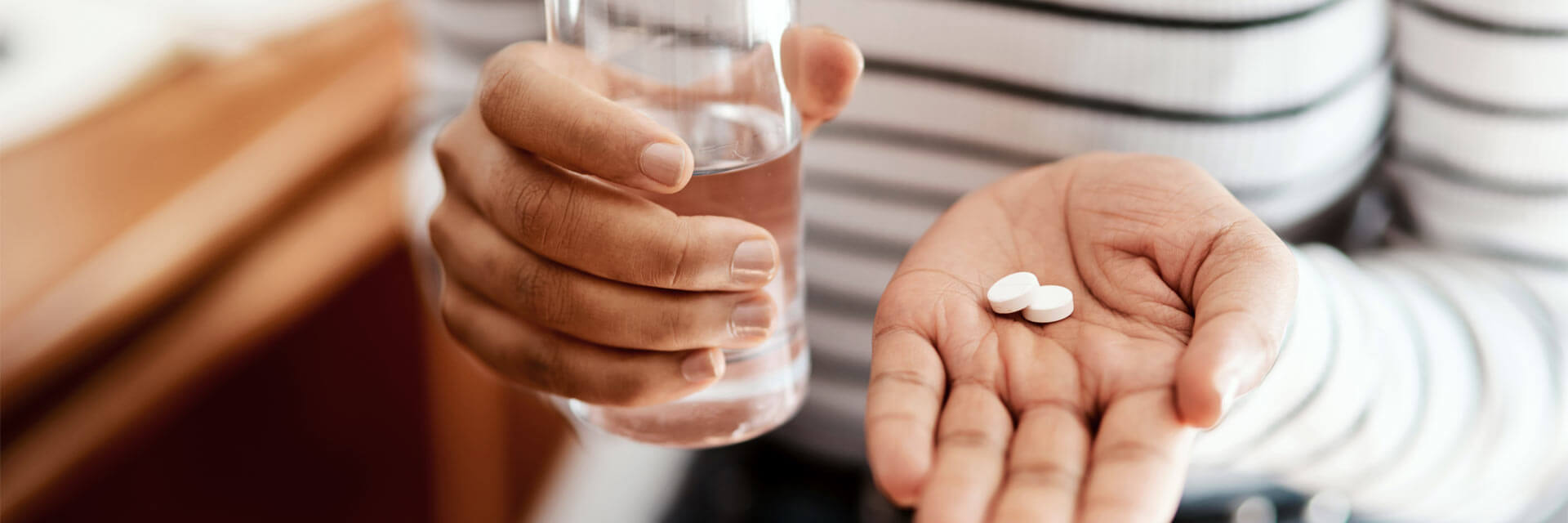 Woman taking her medication at home