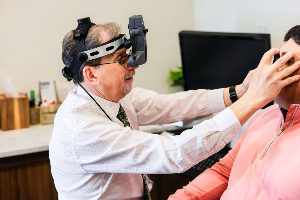 Dr. Mario Palermo with patient testing eyesight