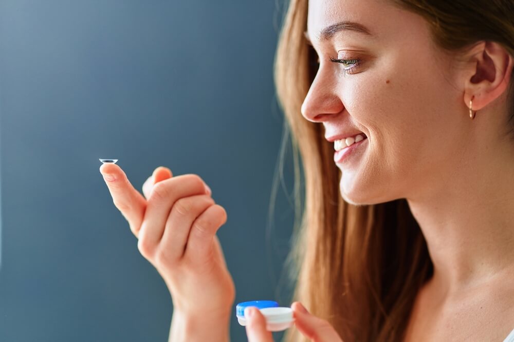 woman putting contact lens on