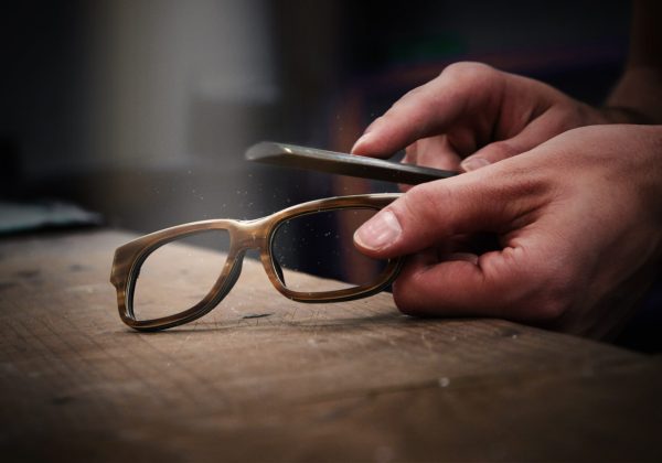 Hands holding glasses frame