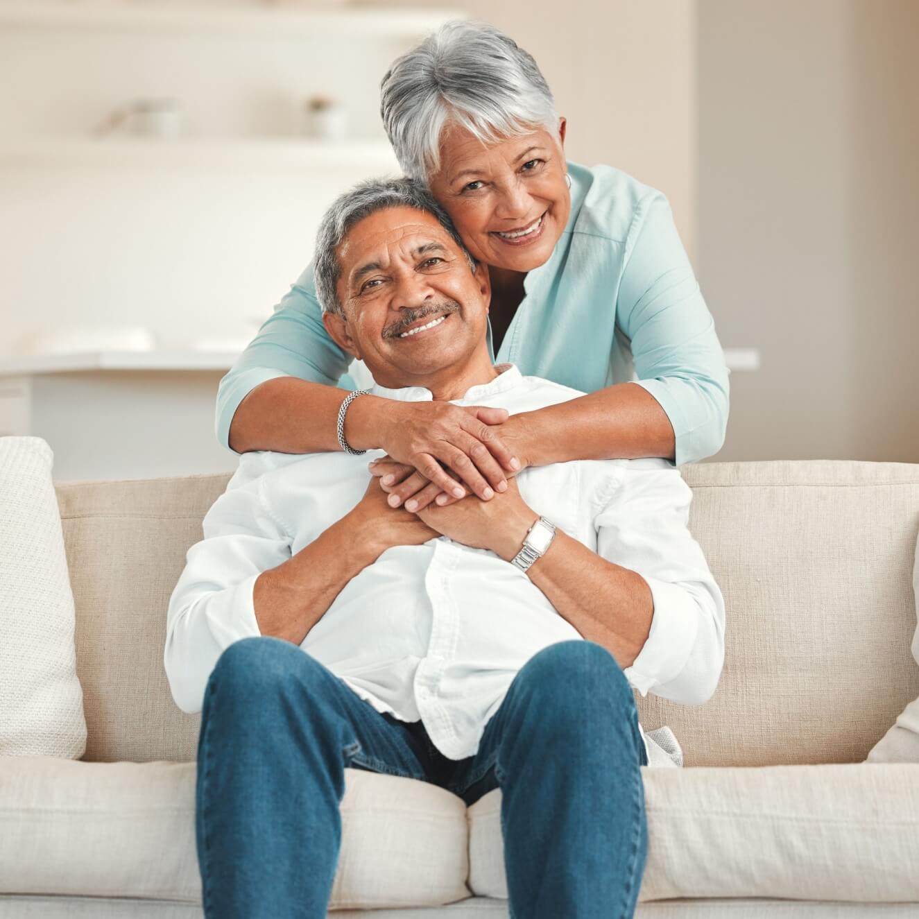 Happy senior couple relaxing on the sofa at home