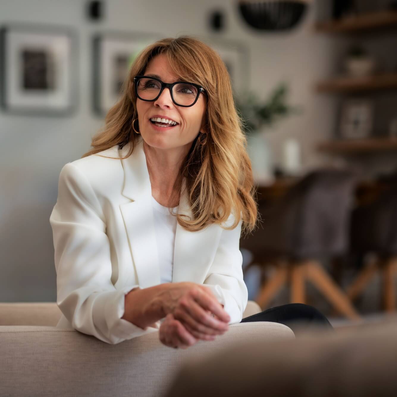 happy attractive woman relaxing in an armchair at home