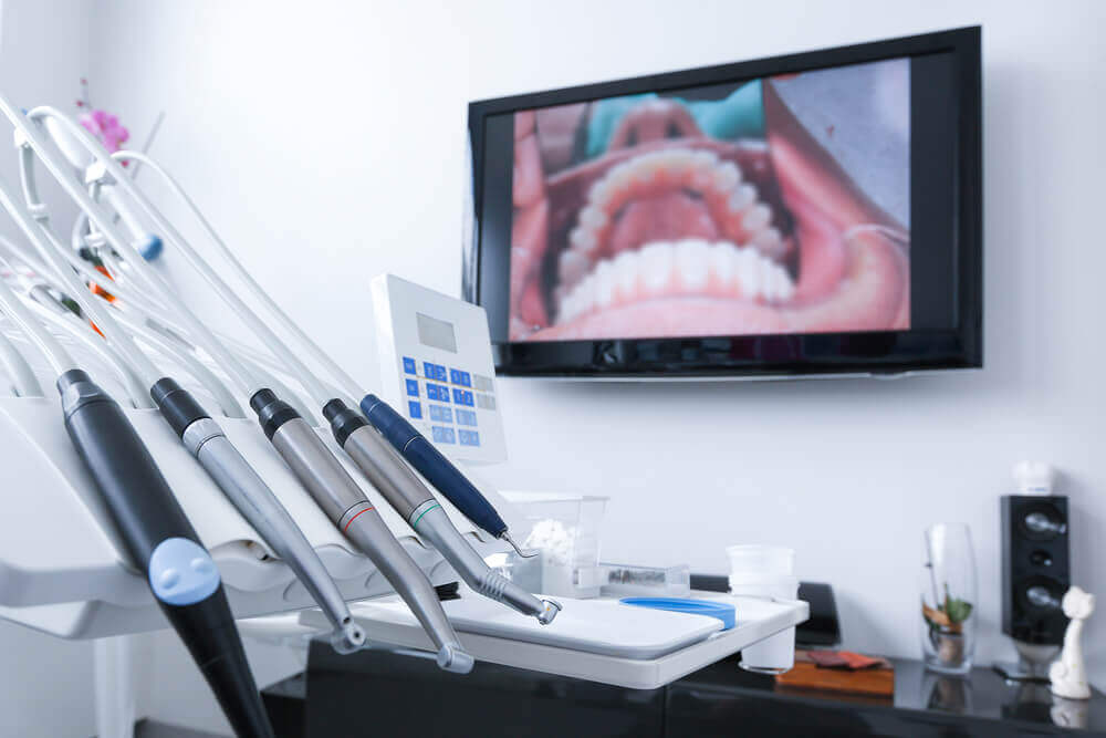 dental office with tools and live picture of teeth in the backgrounds