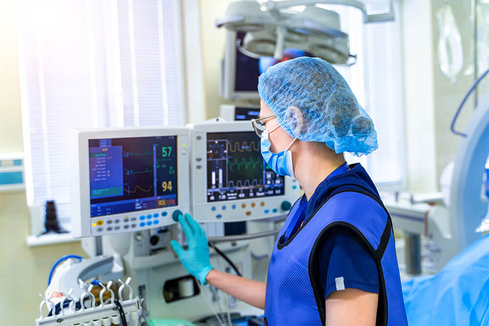 Nurse with medical equipment in the intensive care unit