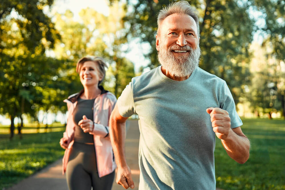energetic fit sportsman spending morning in park and jogging together