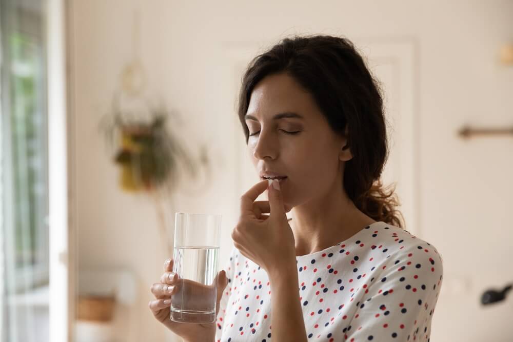 A woman taking pill