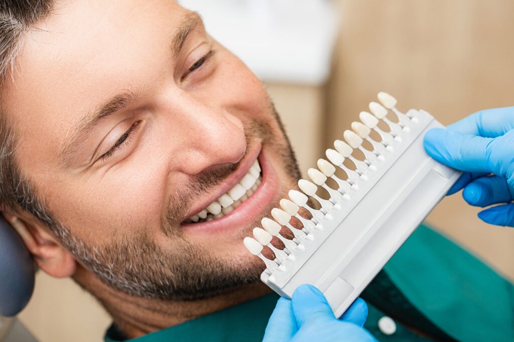 Dentist uses a palette tooth color sample to determine shade