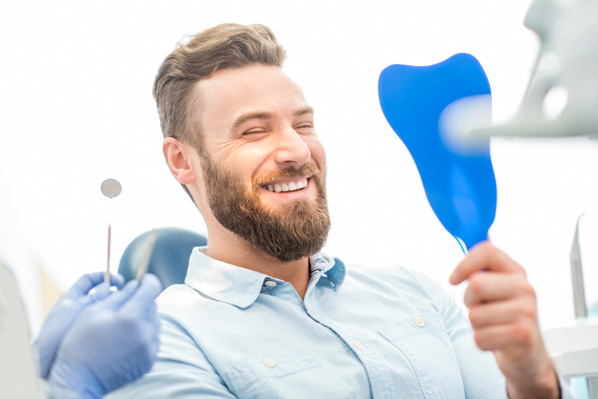 Handsome male patient looking at his beautiful smile