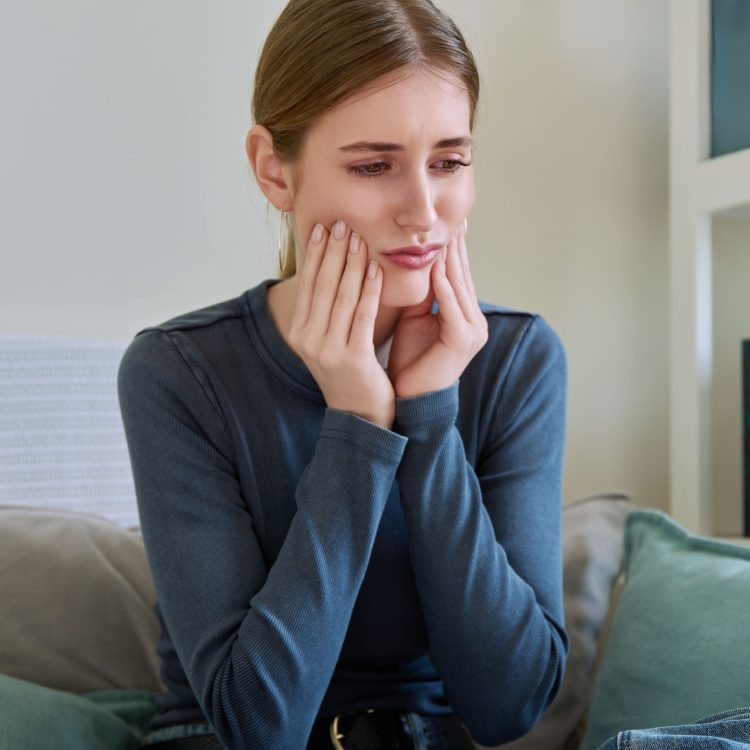 Suffering young teenage female having toothache