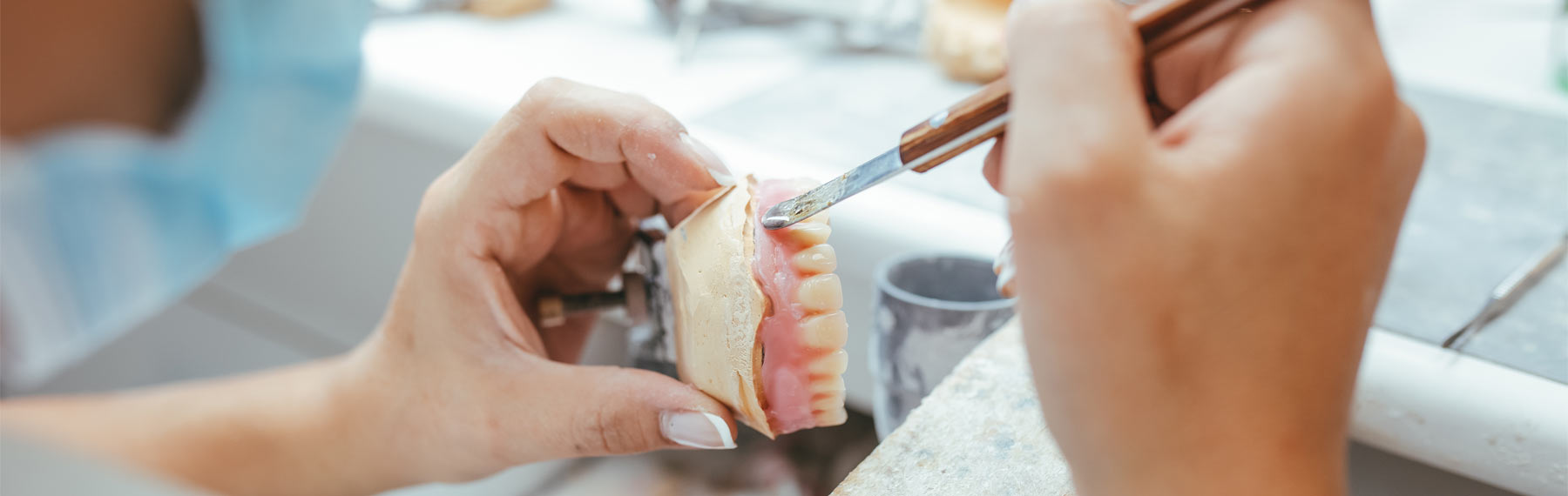 Dental technician fixing a denture