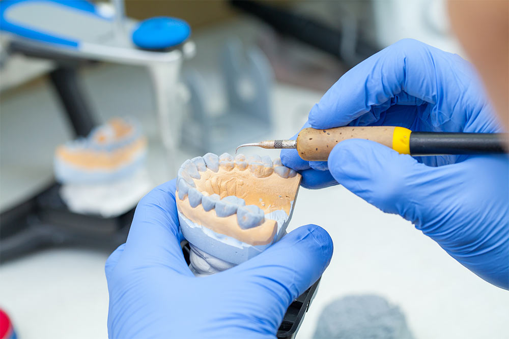 Dental technician working with dentures in a laboratory