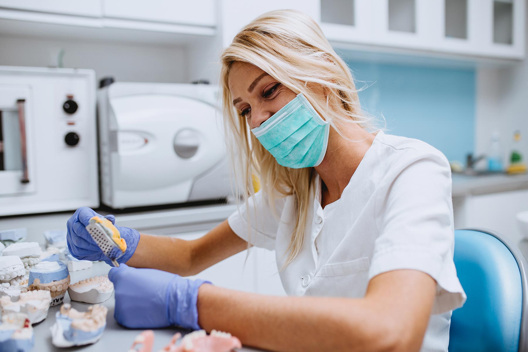 Dental technician making dentures