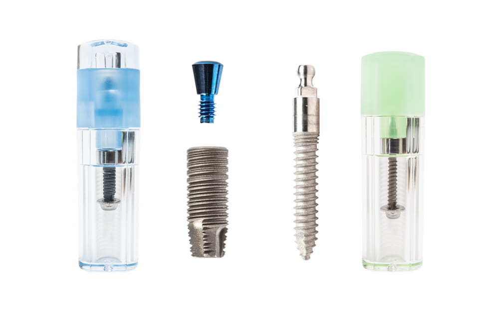 two types of dental Implant with container on white background