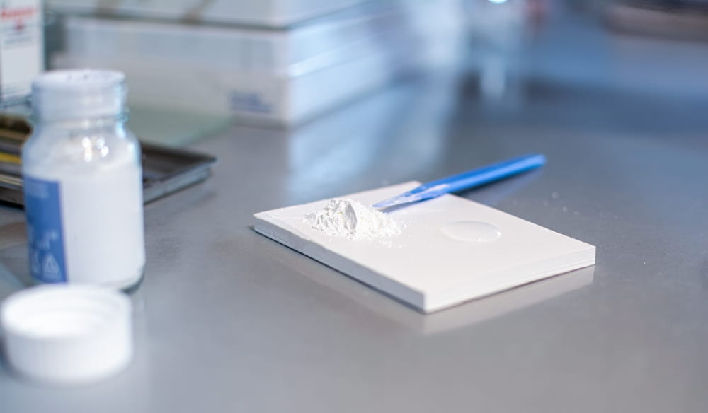 Close up of dental spatula and cement for fillings on desk in dental office.