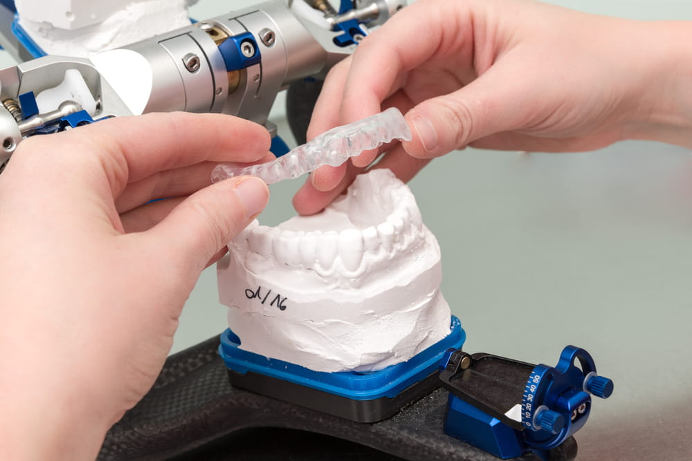 An Occlusal splint is checked in a dental laboratory in an articulator
