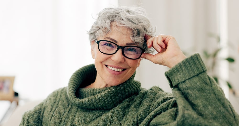 Happy senior woman on sofa to relax in home