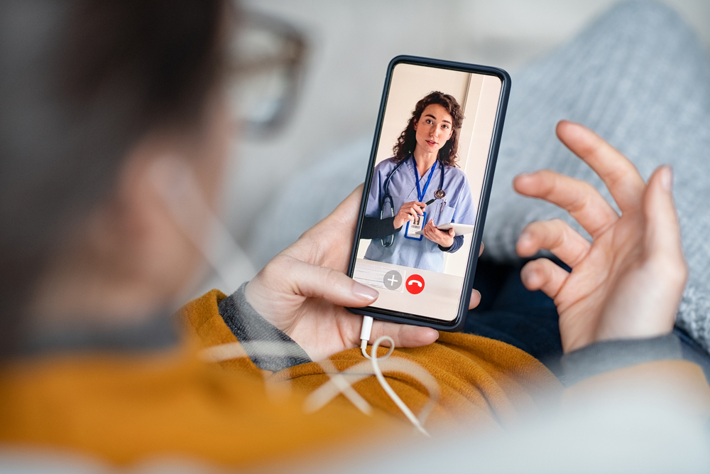 Young woman patient in conversation with specialist over video conferencing