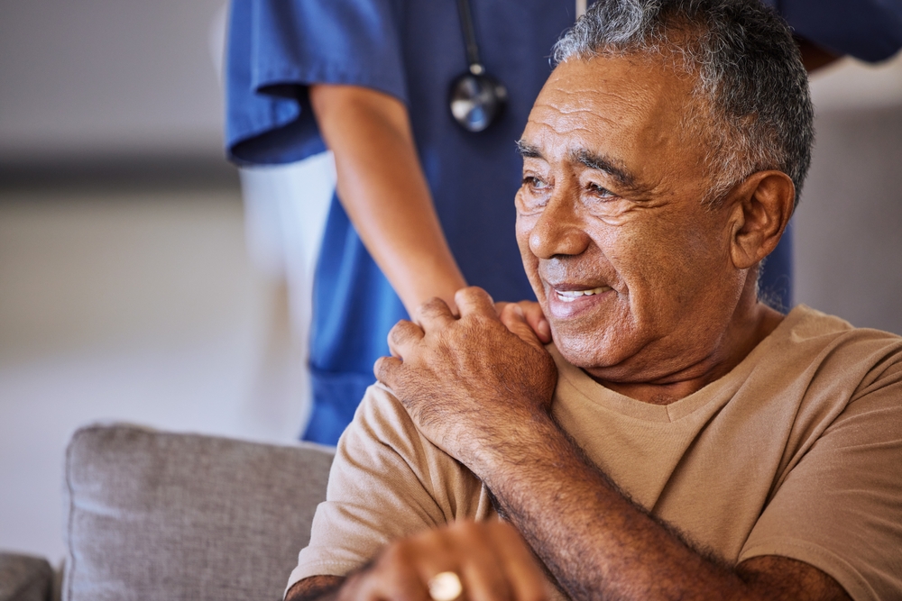 Nurse giving man support during recovery
