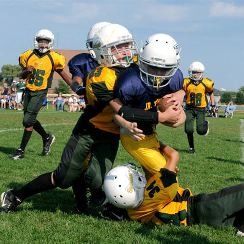 Youth Football Players playing at field