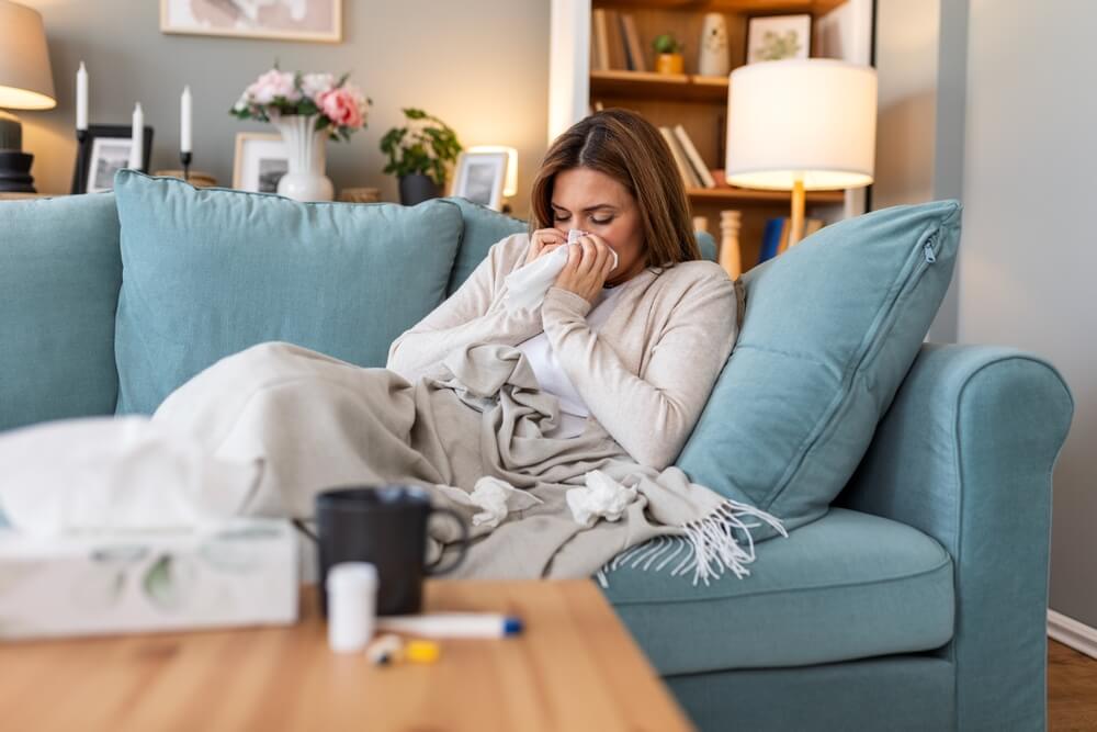 Woman Feeling Sick And Sneezing In Paper Wipe