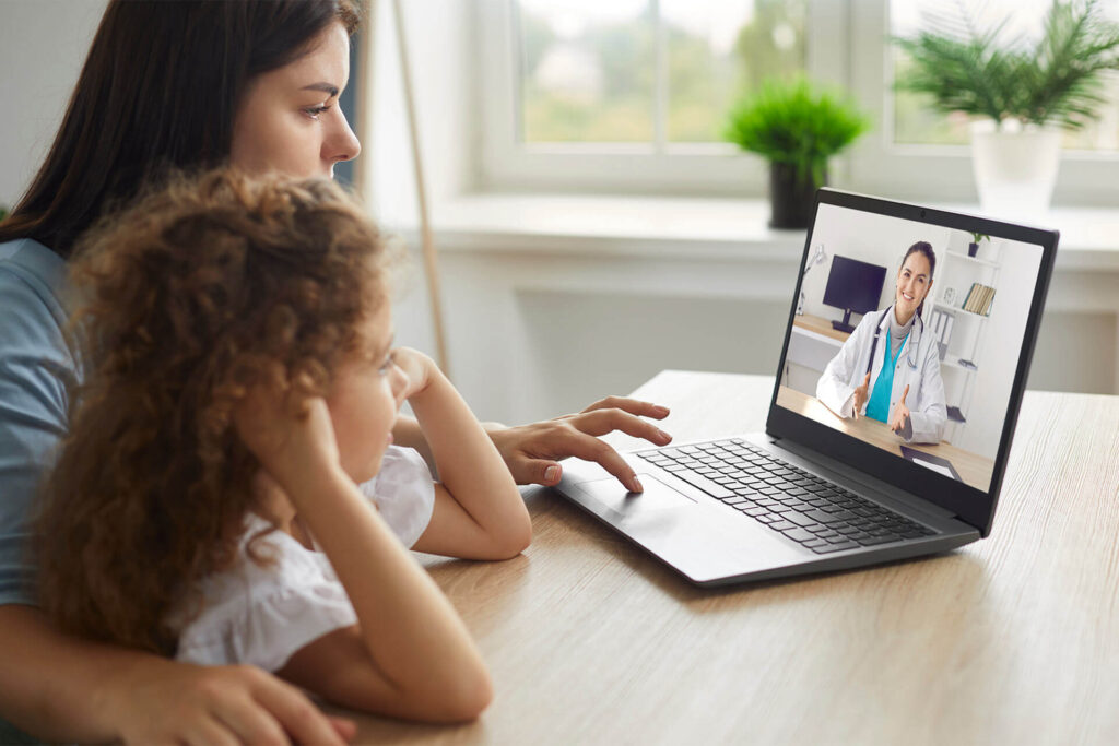 Mother and child having online telehealth consultation with doctor