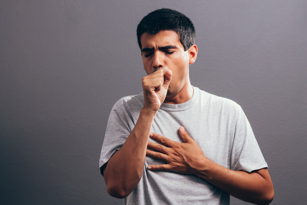 Man coughing into his fist