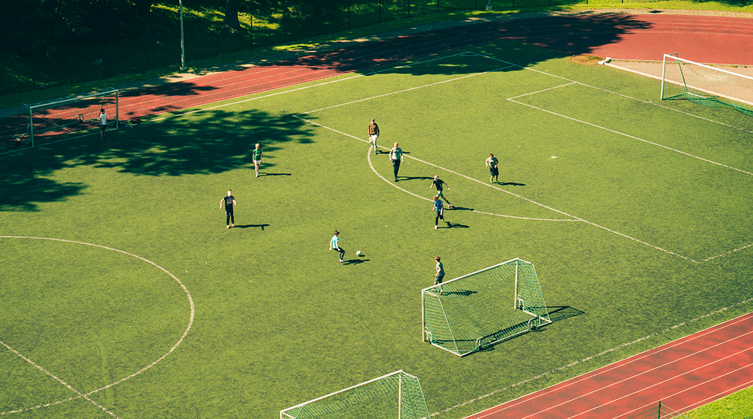 Kids playing casual soccer on grass soccer field