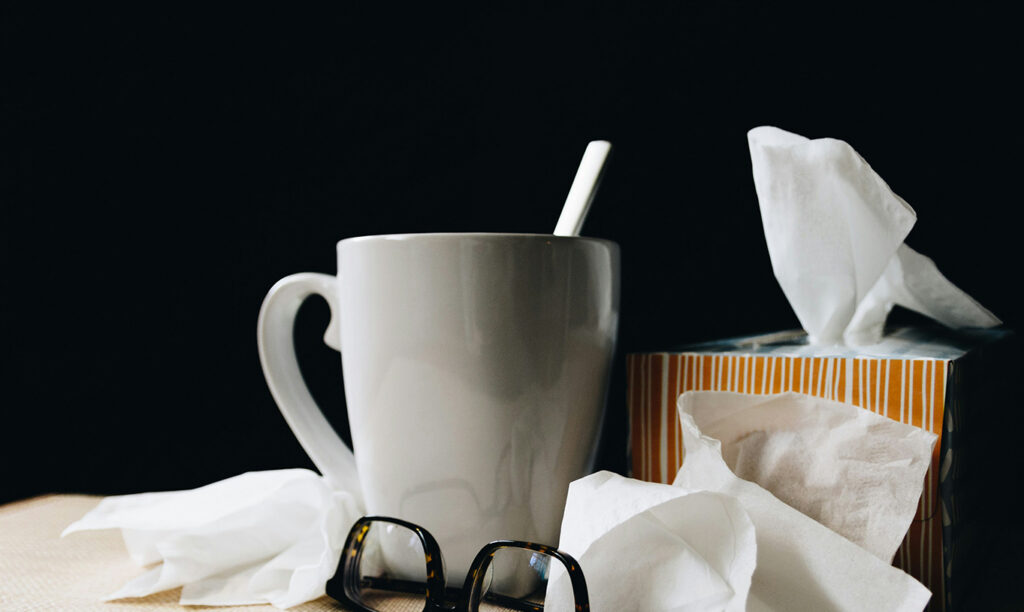 Tea cup with tissues and glasses.