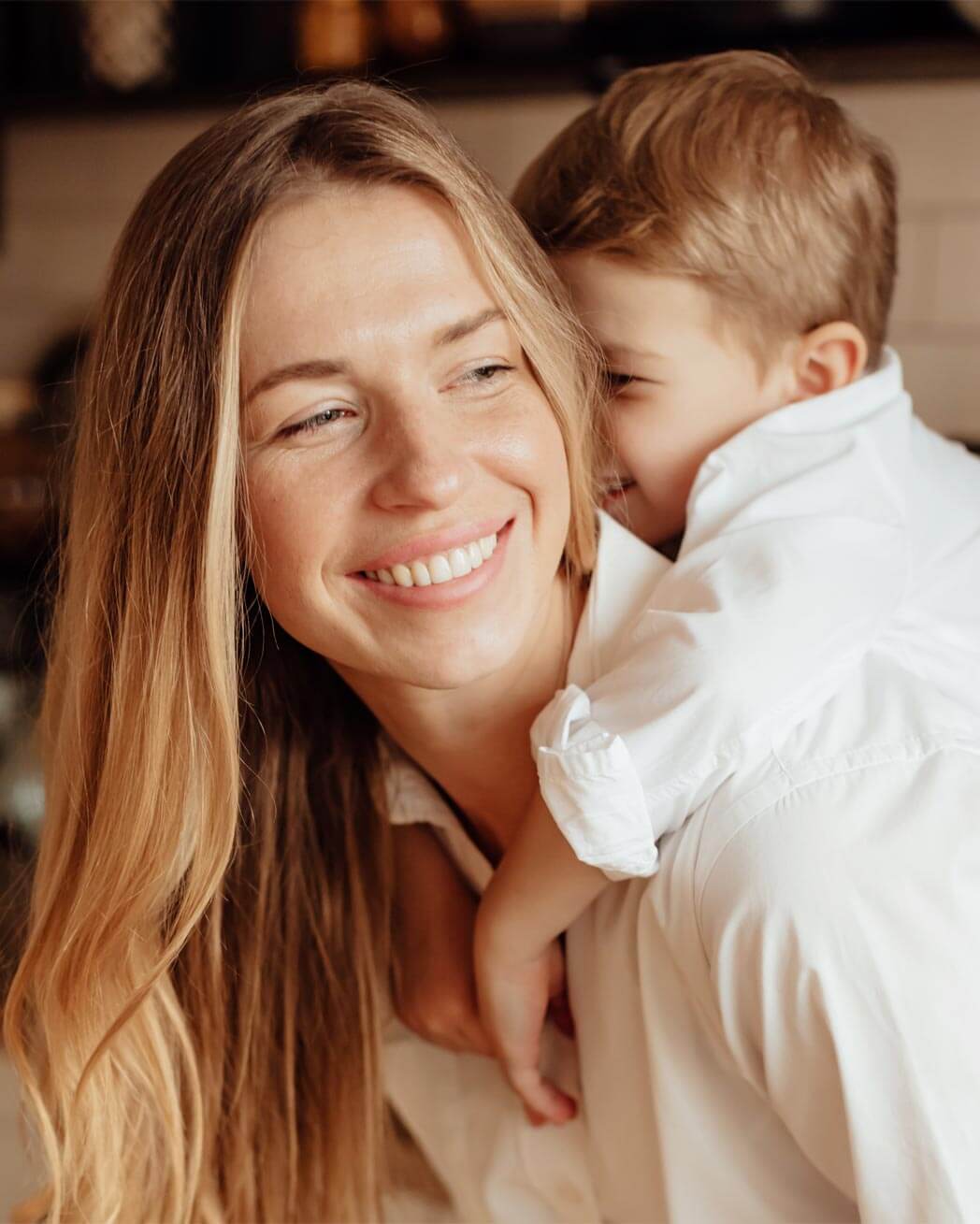 Happy mother and son smiling at each other