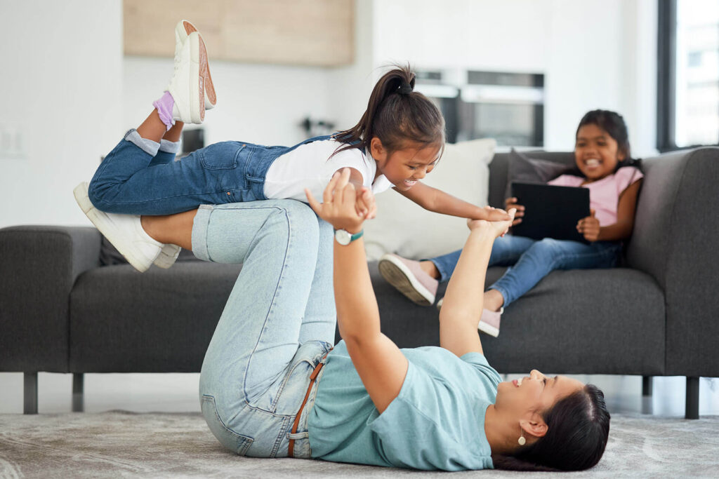 Mother being funny with children in house