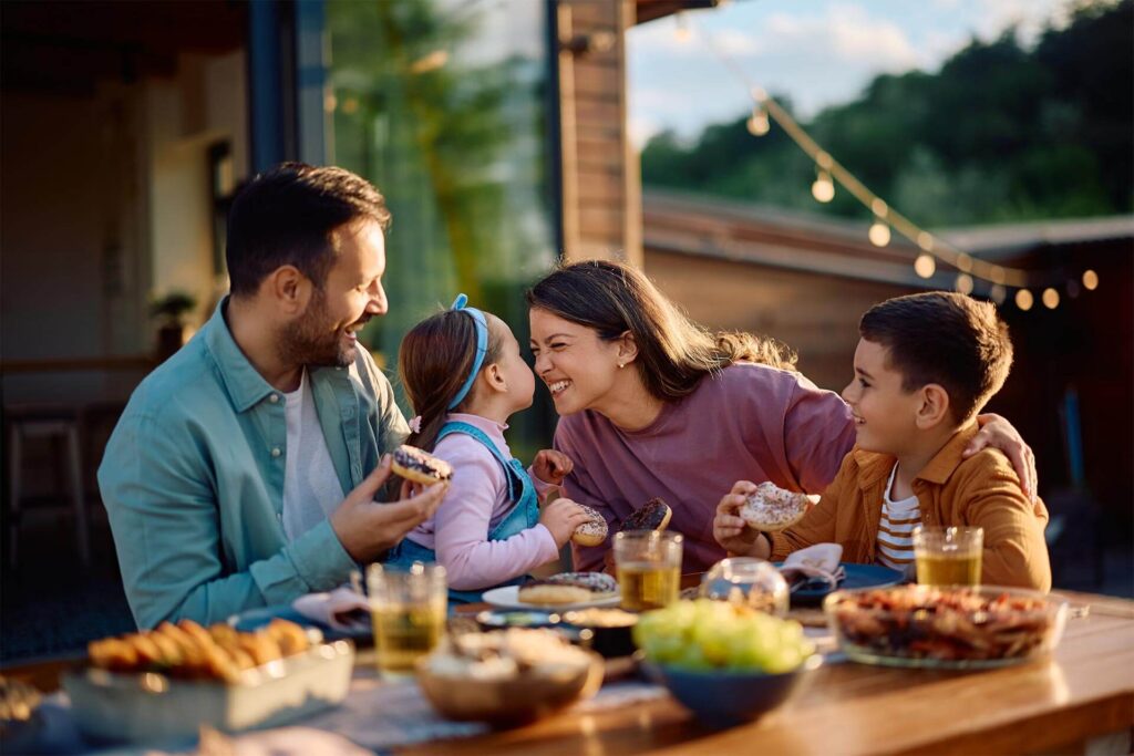 Happy family having fun while eating at dining table