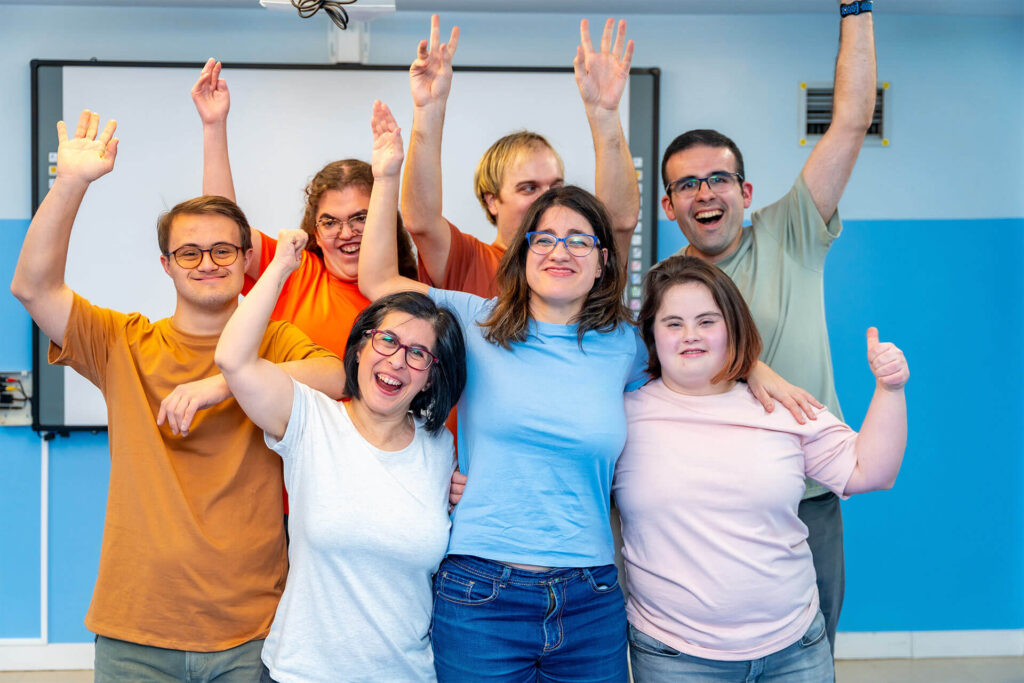 Happy people with special needs posing after gymnastic class