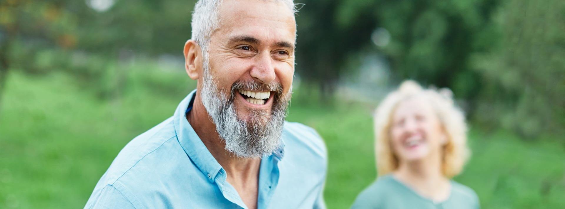 Happy active mid aged adult couple having fun walking