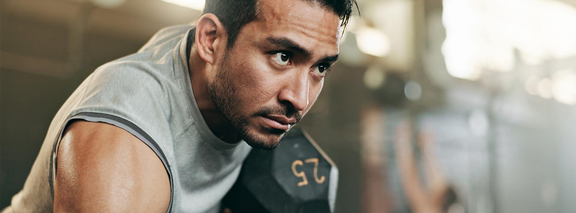 Active male person lifting weight for training