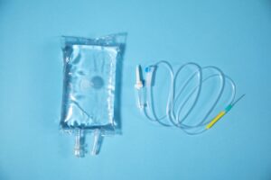 Infusion bag in the blue background. IV drip chamber