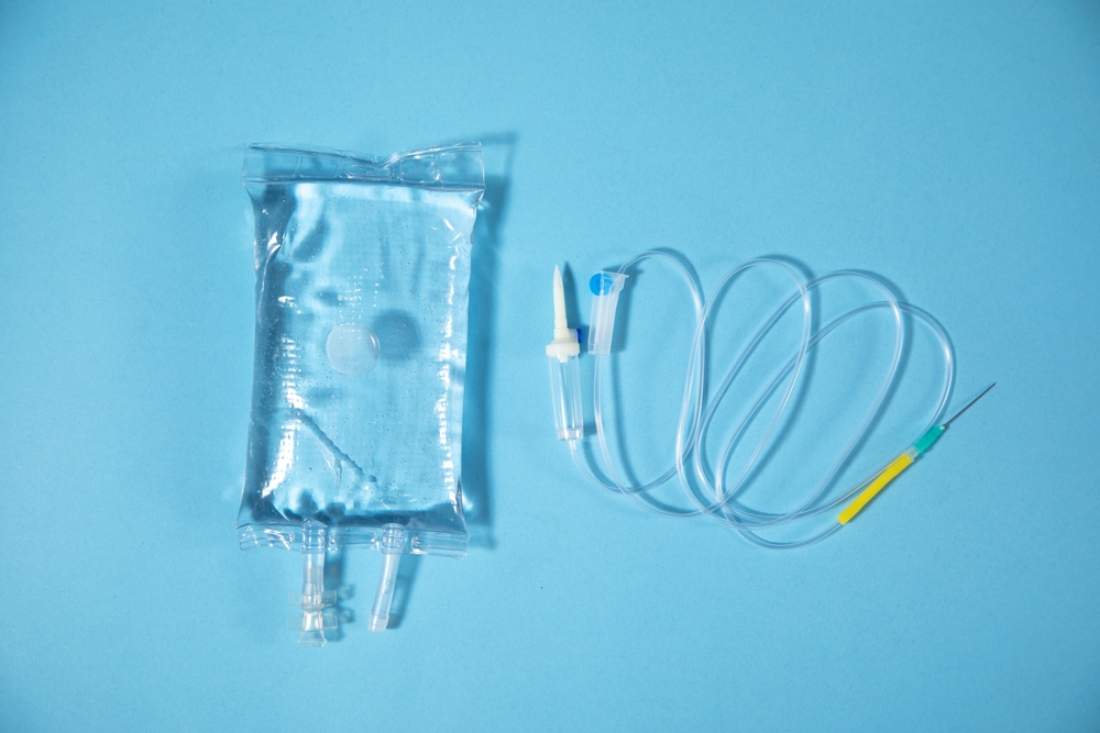 Infusion bag in the blue background. IV drip chamber