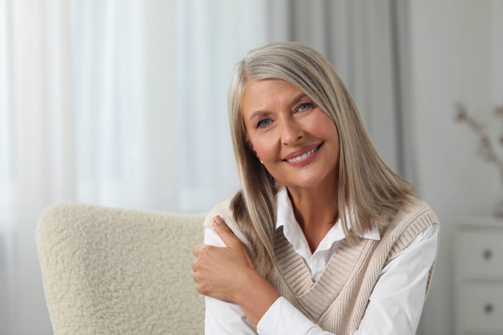 Portrait of beautiful middle aged woman at home, space for text