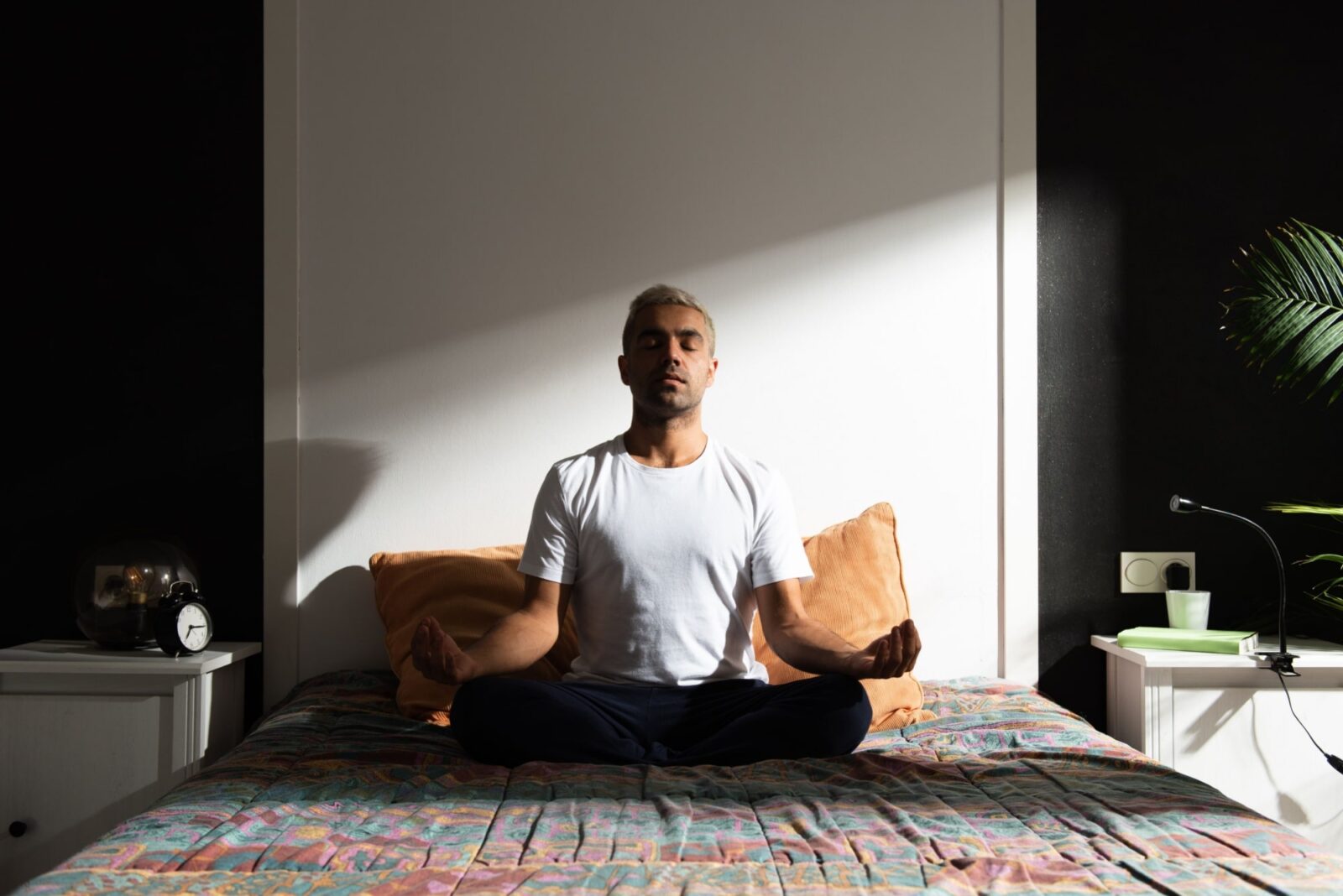 man meditating in bedroom