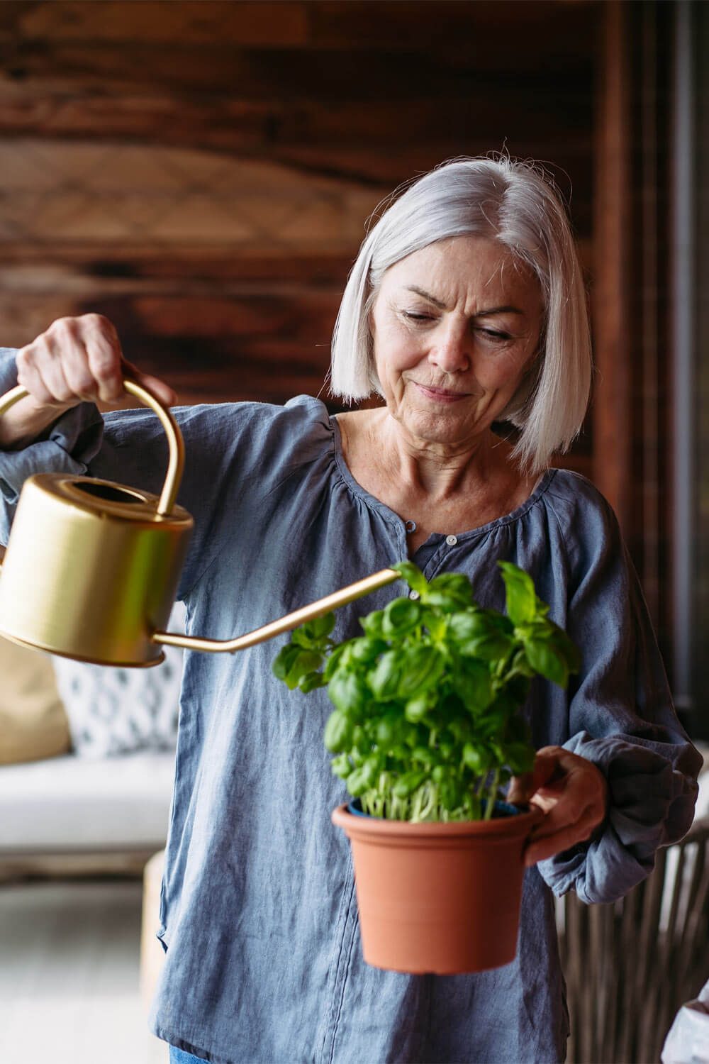 beautiful mature woman taking care of plants