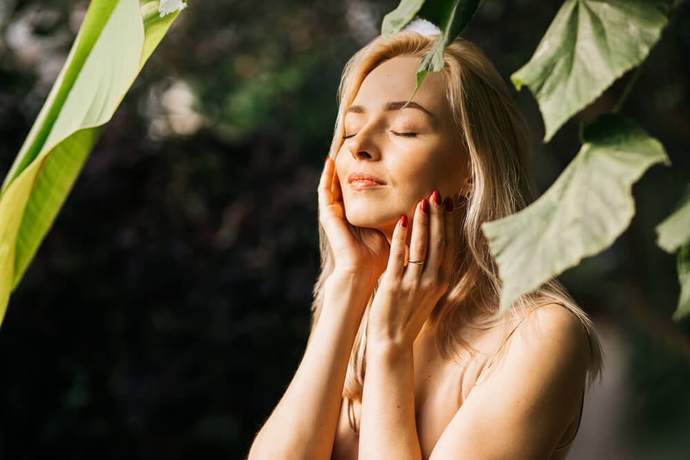 Charming young woman enjoying summer sun