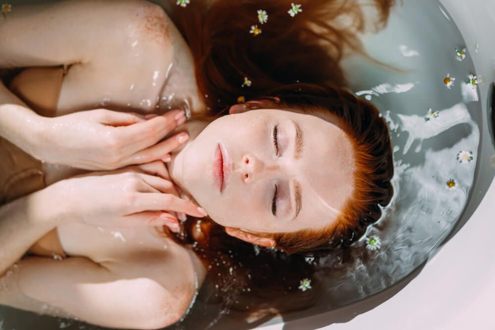 beautiful young woman lying in the bathtub