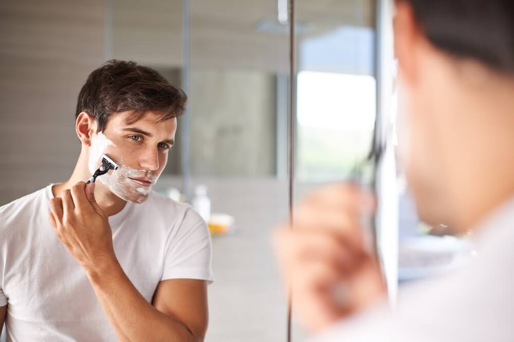 Man in bathroom for facial grooming