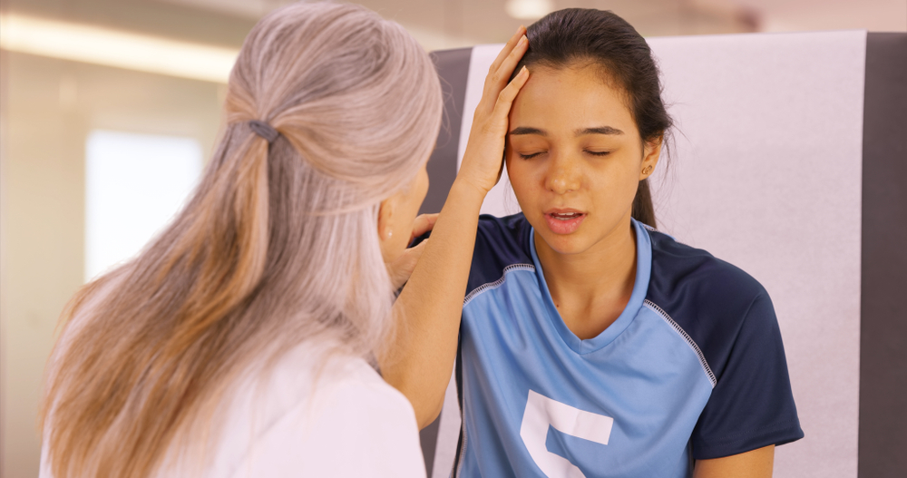 A concussed soccer player seeks help at the doctors office