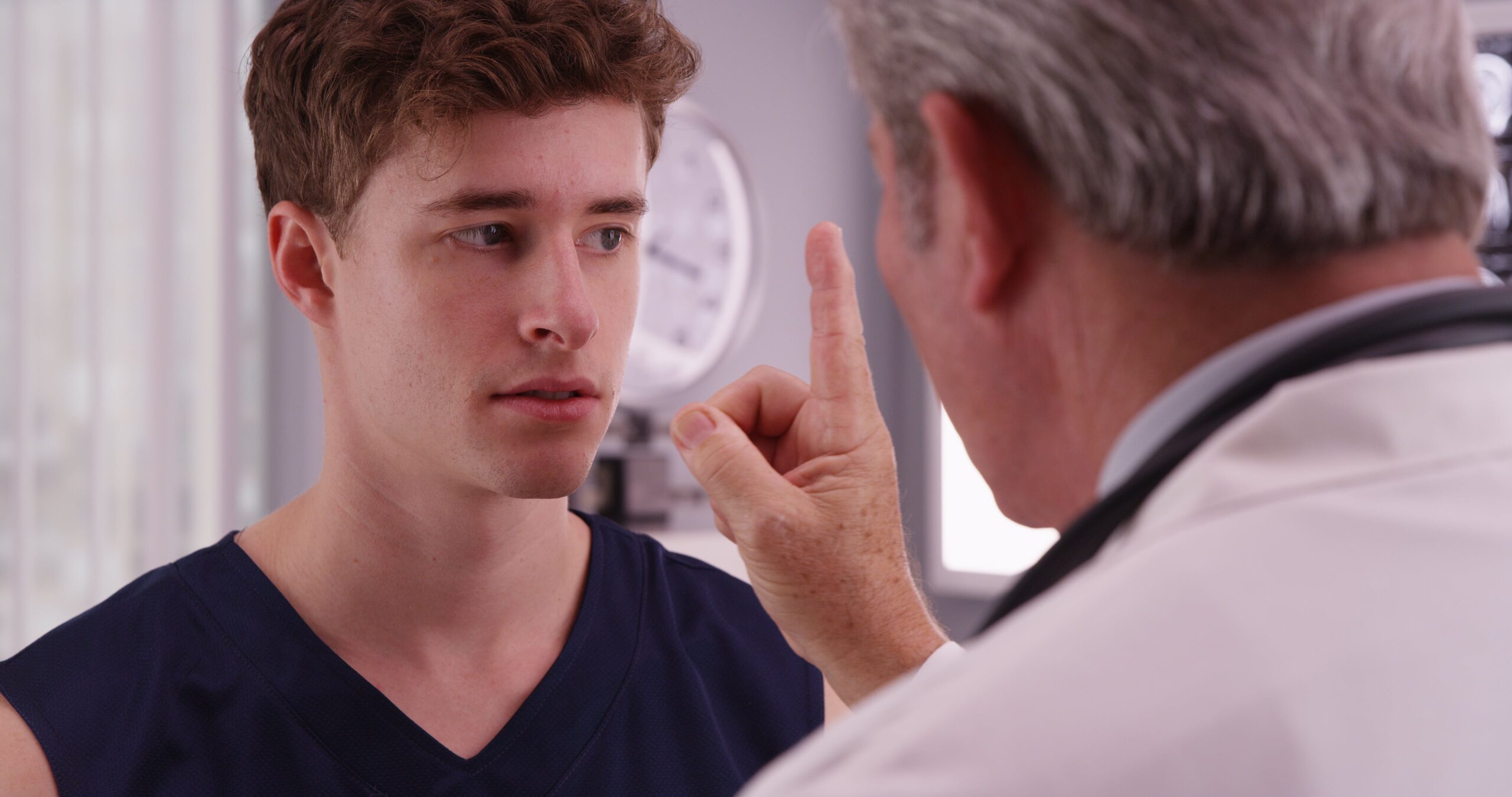 young sports athlete having eyesight checked by doctor